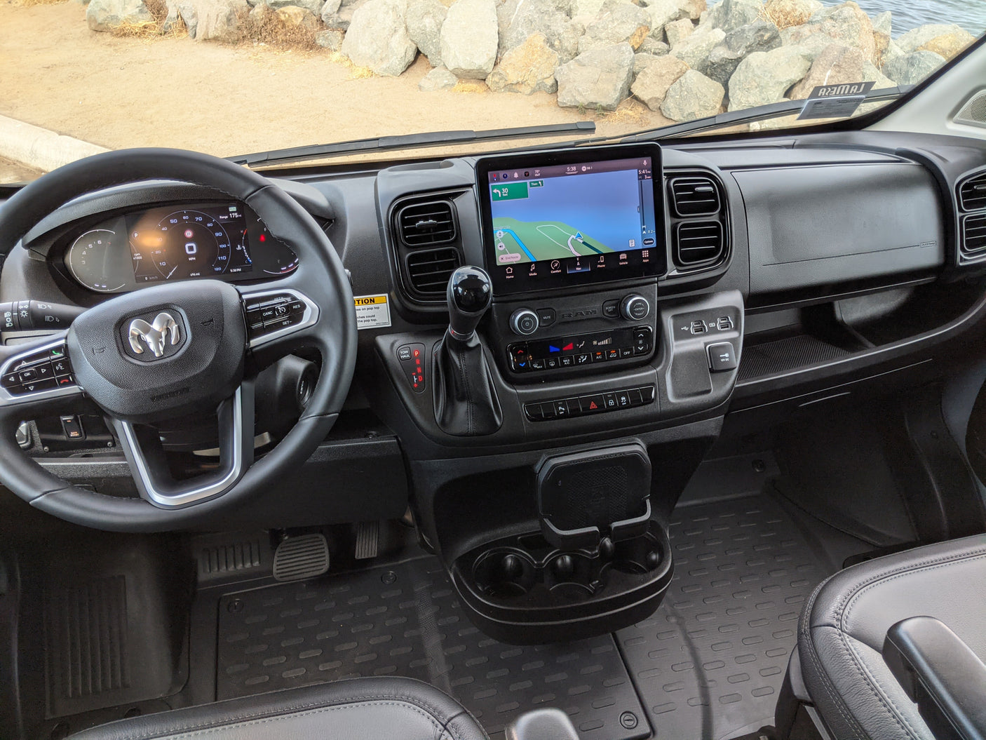 Modern RV rental dashboard interior, featuring a digital cluster, steering wheel, and navigation display.