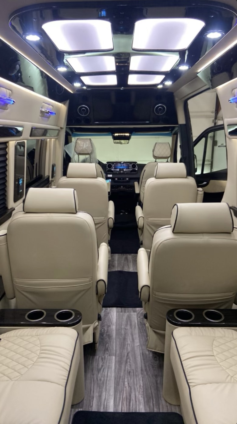 showcasing its sleek design.|Luxurious RV rental interior: cream-colored captain's chairs with diamond stitching
