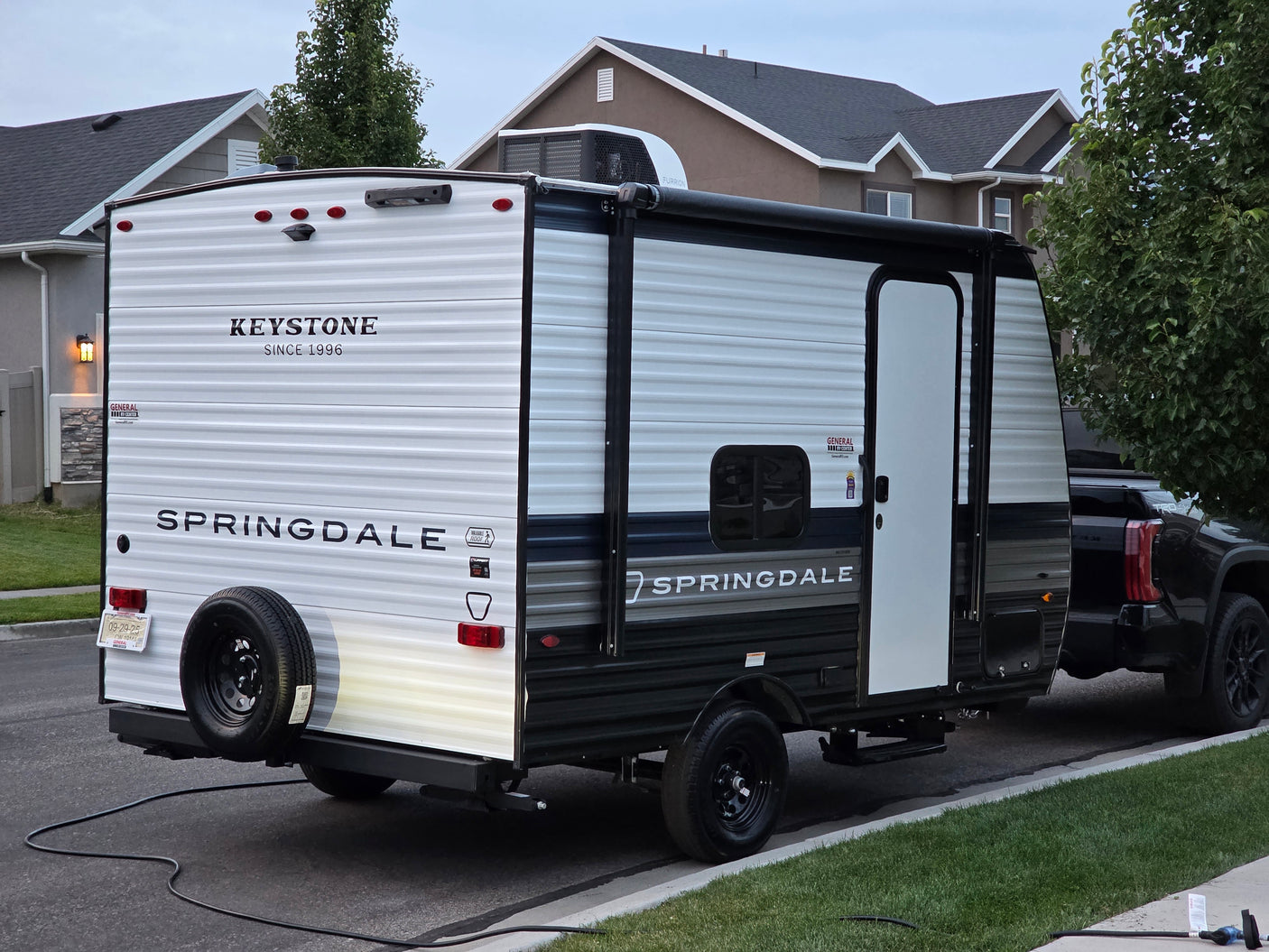This Keystone Springdale travel trailer, an RV rental, is hitched to a truck, ready for its next adventure.