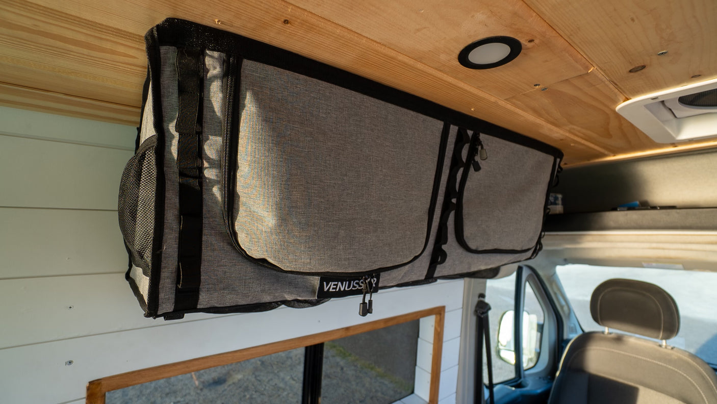 Maximizing space in this rv rental campervan with an overhead fabric storage bag, ideal for organizing your adventure essentials.