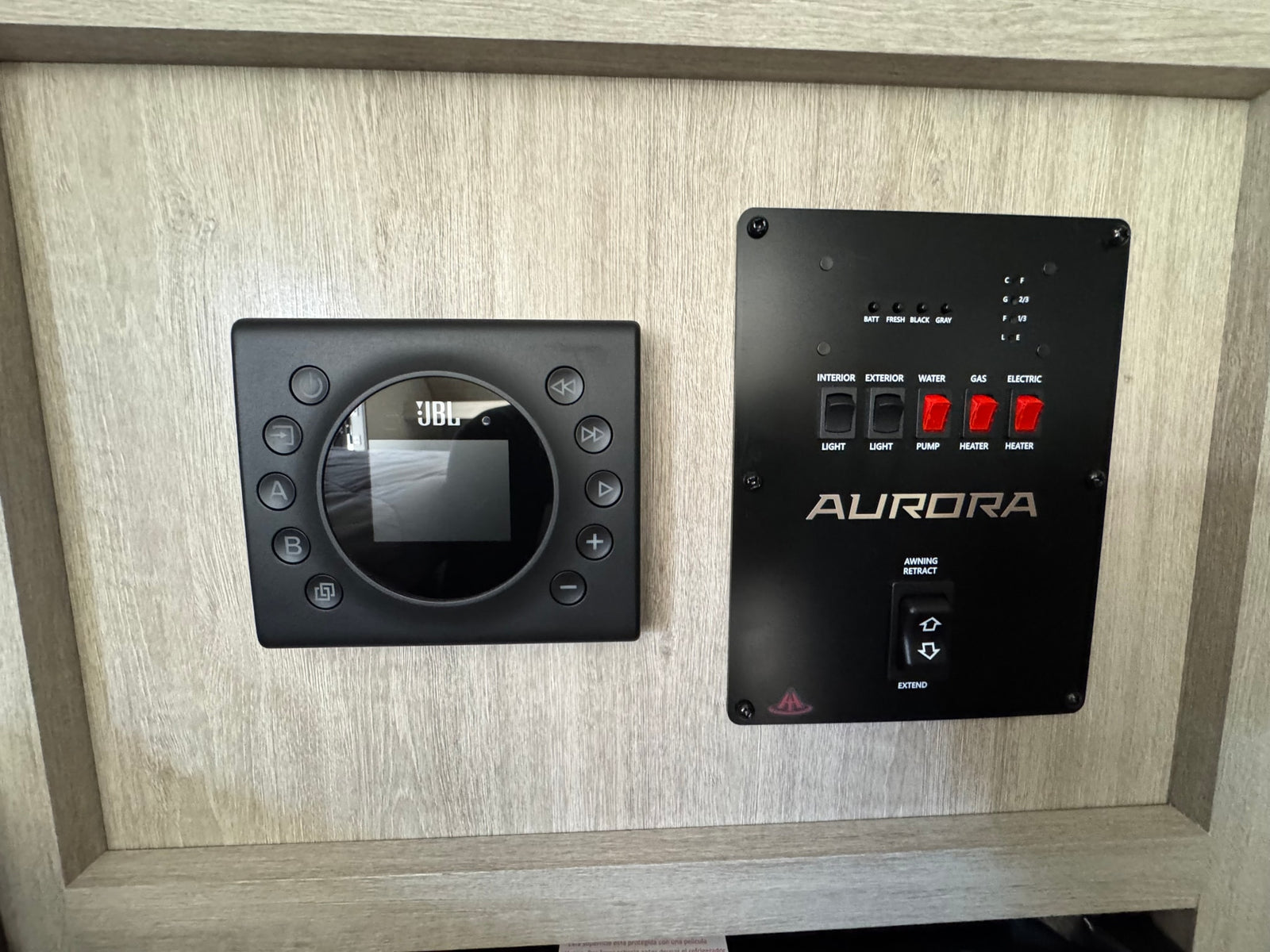 RV rental tech: JBL stereo, Aurora control panel for water tanks, lights, heaters, and awning extend/retract.