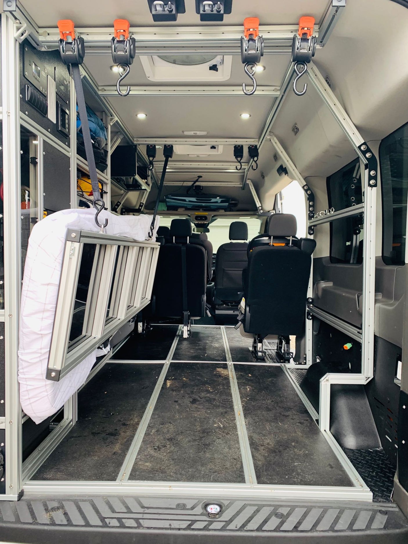 parked on gravel.|Spacious RV rental interior featuring a large overhead TV and child safety seat