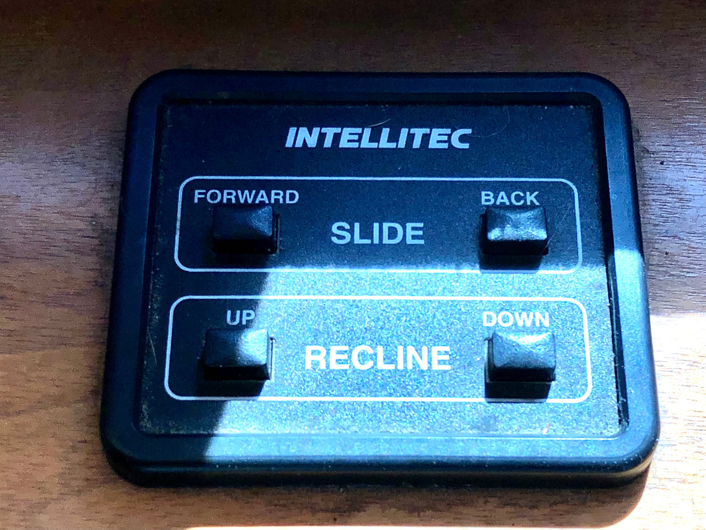 Intellitec power seat control in an RV rental, showing buttons for SLIDE (forward/back) and RECLINE (up/down) functions.