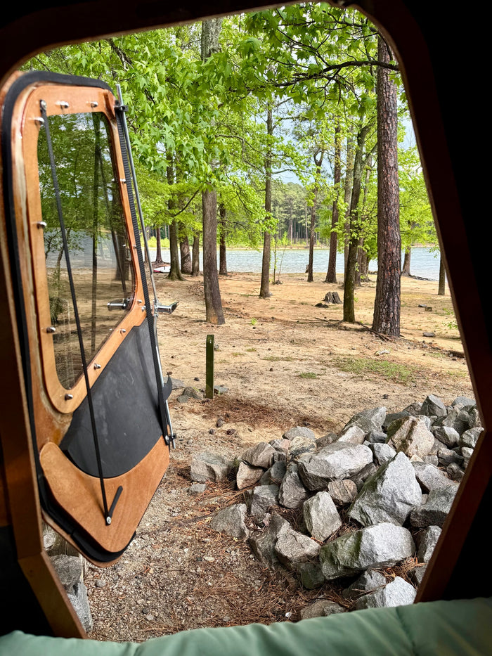 and calm water.|An RV rental's comfy interior with a bed