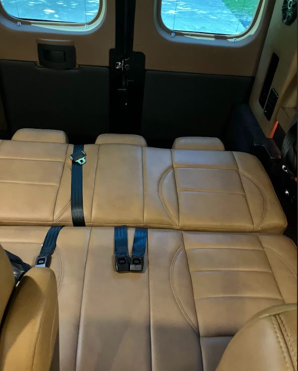 featuring plush tan seating and smart design.|This RV rental's cockpit shows the black steering wheel with a Ram logo