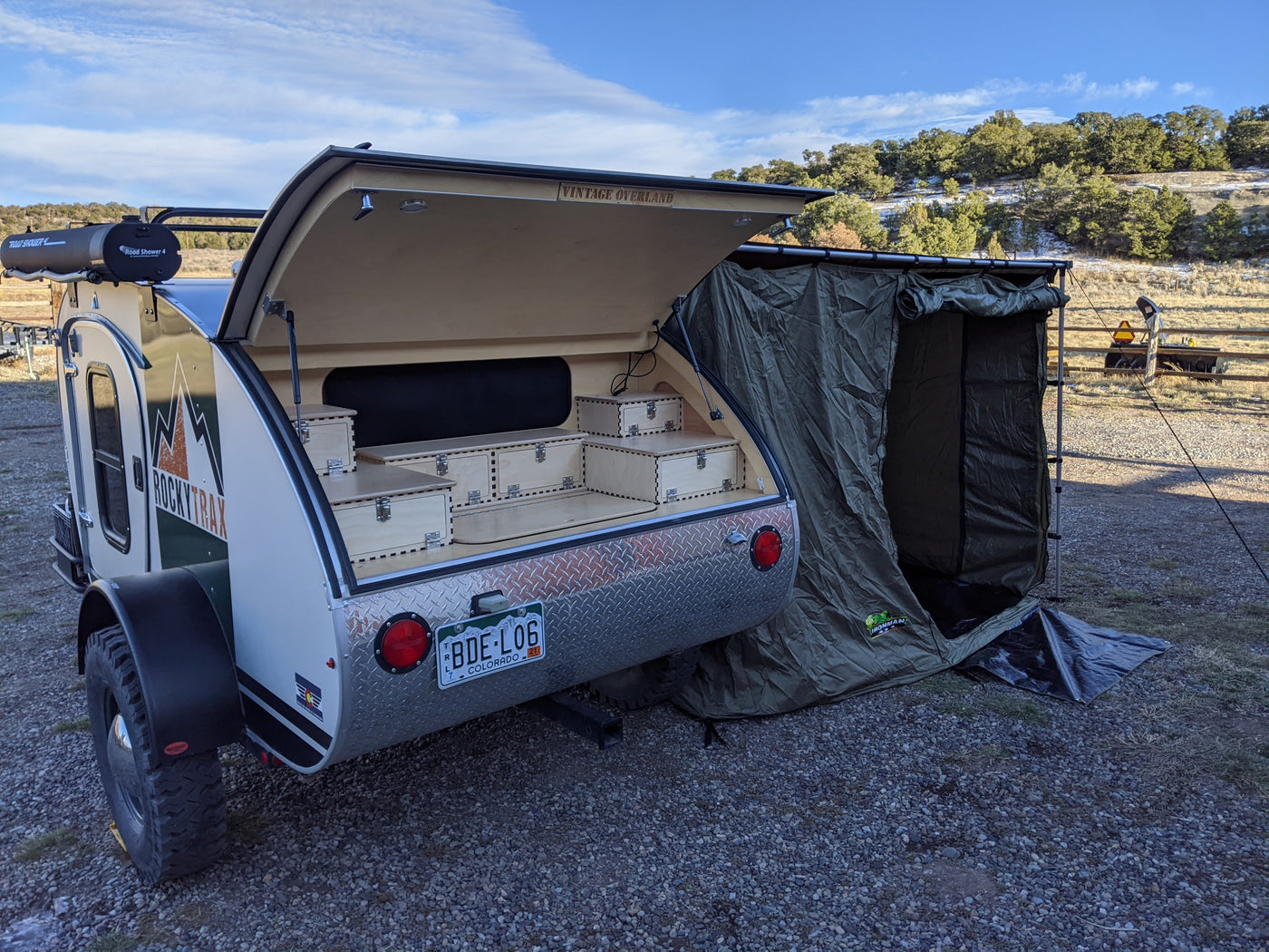 Overland rv rental: RockyTrax teardrop camper with rear galley, rooftop shower, and side tent ready for adventure. — photo 15