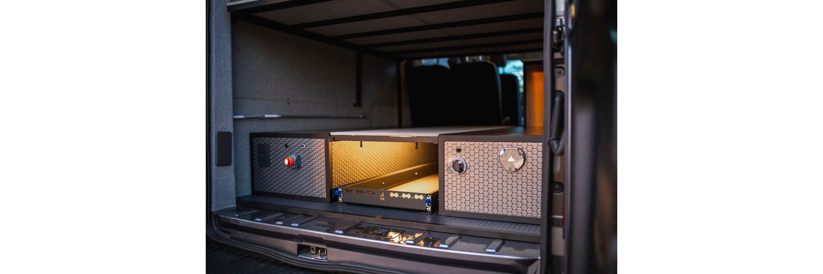 and a pull-out kitchen/gear tray for travel.|RV rental van's rear: modular storage system