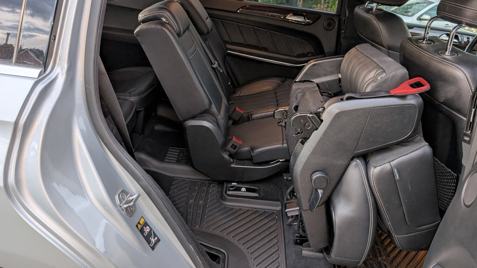 Car interior with versatile folding seats, perfect for family travel or cargo in an RV rental alternative.