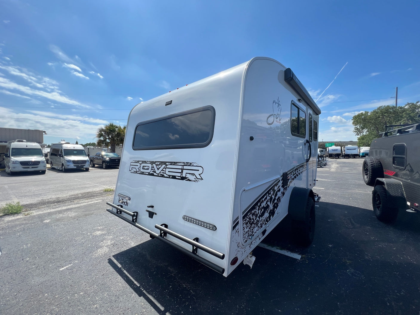 and large windows.|A modern rv rental interior showcasing a compact kitchen