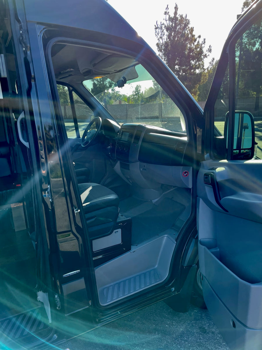 RV rental Mercedes-Benz Sprinter van with both front doors open, showcasing the spacious interior.