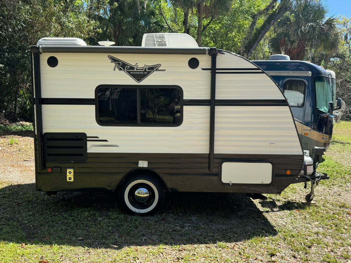 This retro-style travel trailer is ready for your next RV rental adventure. White & dark brown — photo 1