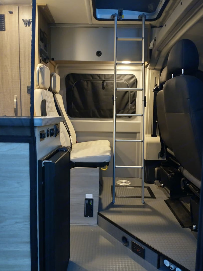 offering stunning desert views.|RV rental comfort: Pop-top camper bed with a beautiful lakeside view