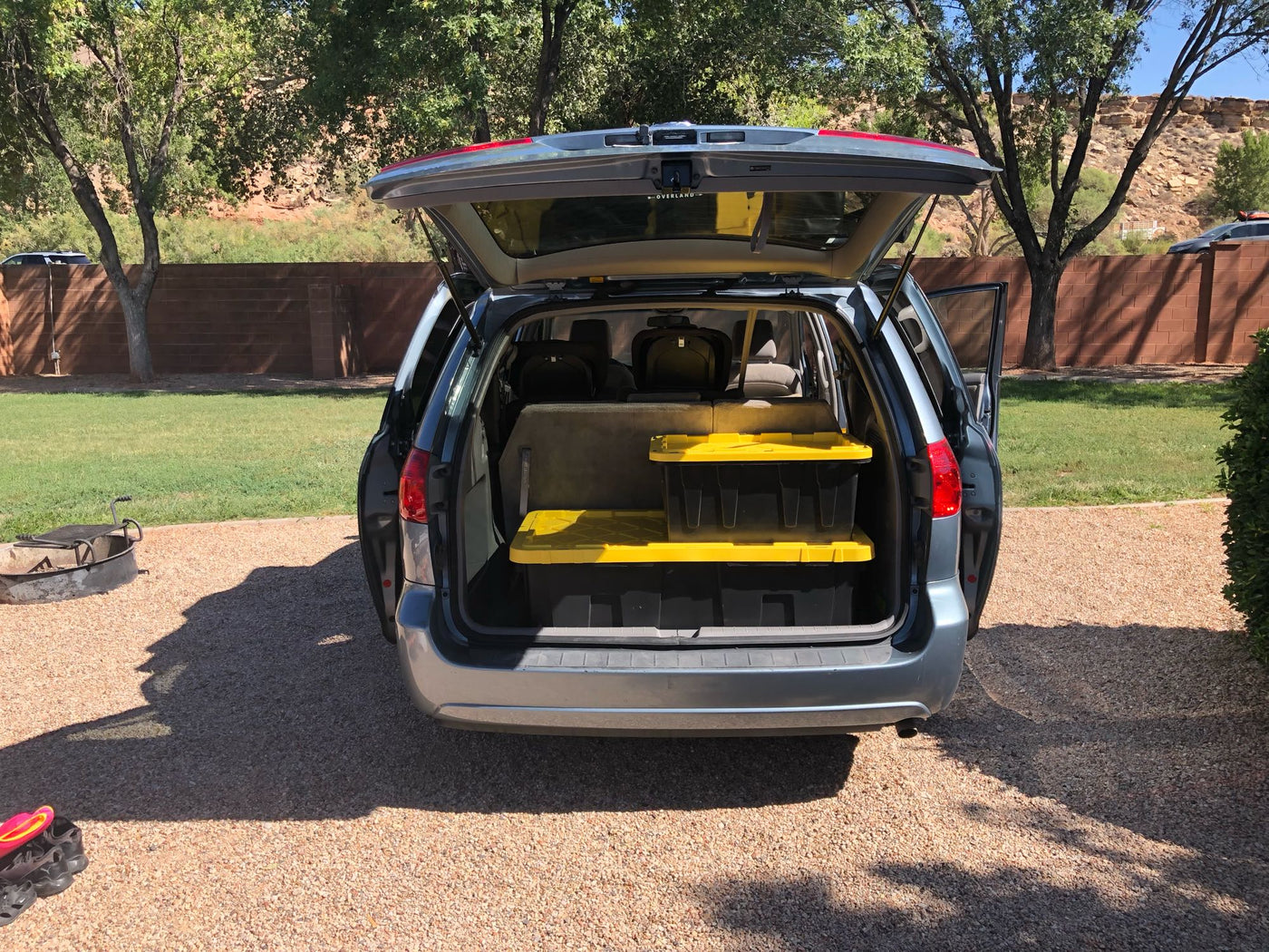 ready for an adventure trip. Vehicle setup evokes an RV rental experience.|A large black storage bin for an RV rental is packed with camping gear: a folding chair — photo 12