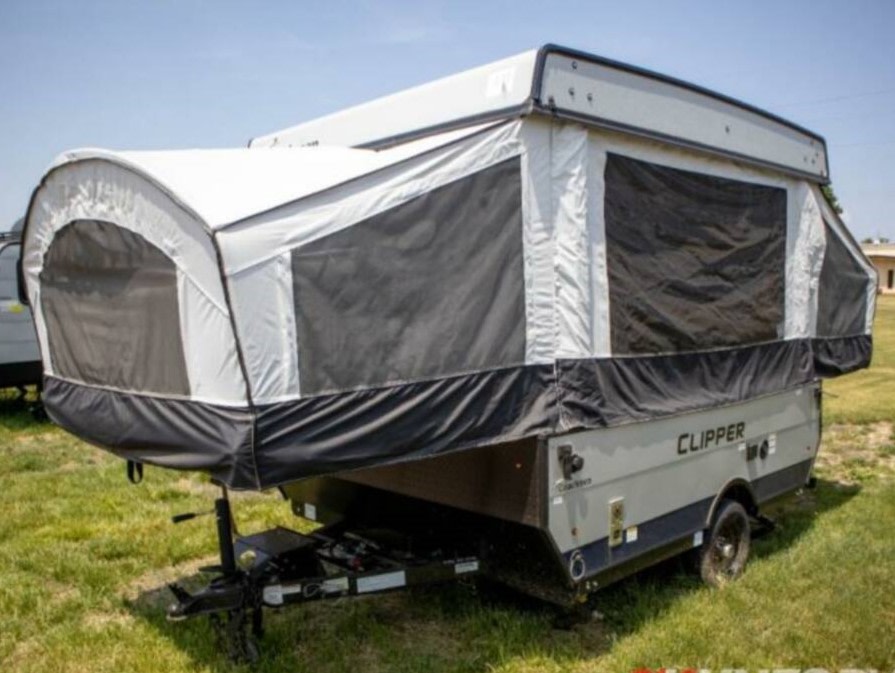 featuring a central dinette with benches and a rear bed.|View inside a bright rv rental pop-up camper