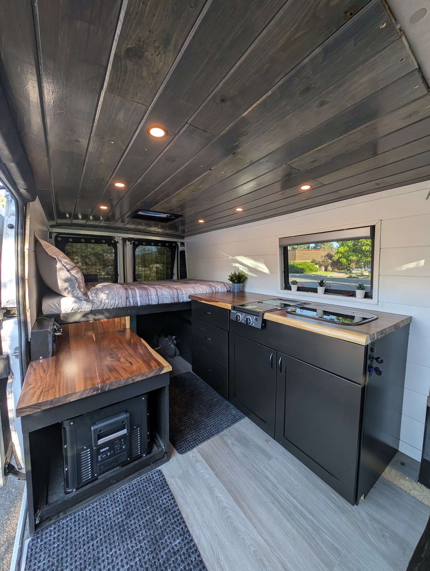 and ceiling lights.|Modern RV rental kitchen with a 2-burner stove — photo 4