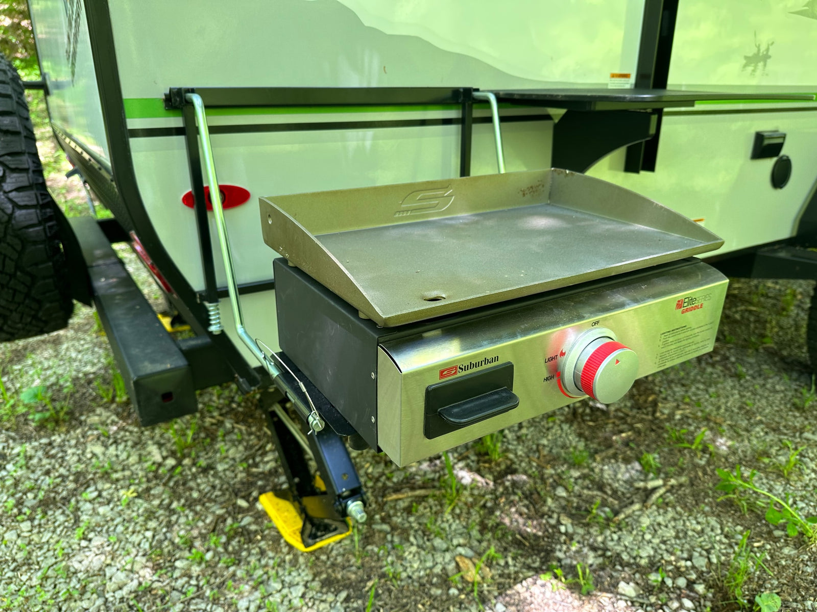Enjoy outdoor cooking with this RV rental's side-mounted Suburban Elite Series Griddle for camping convenience.