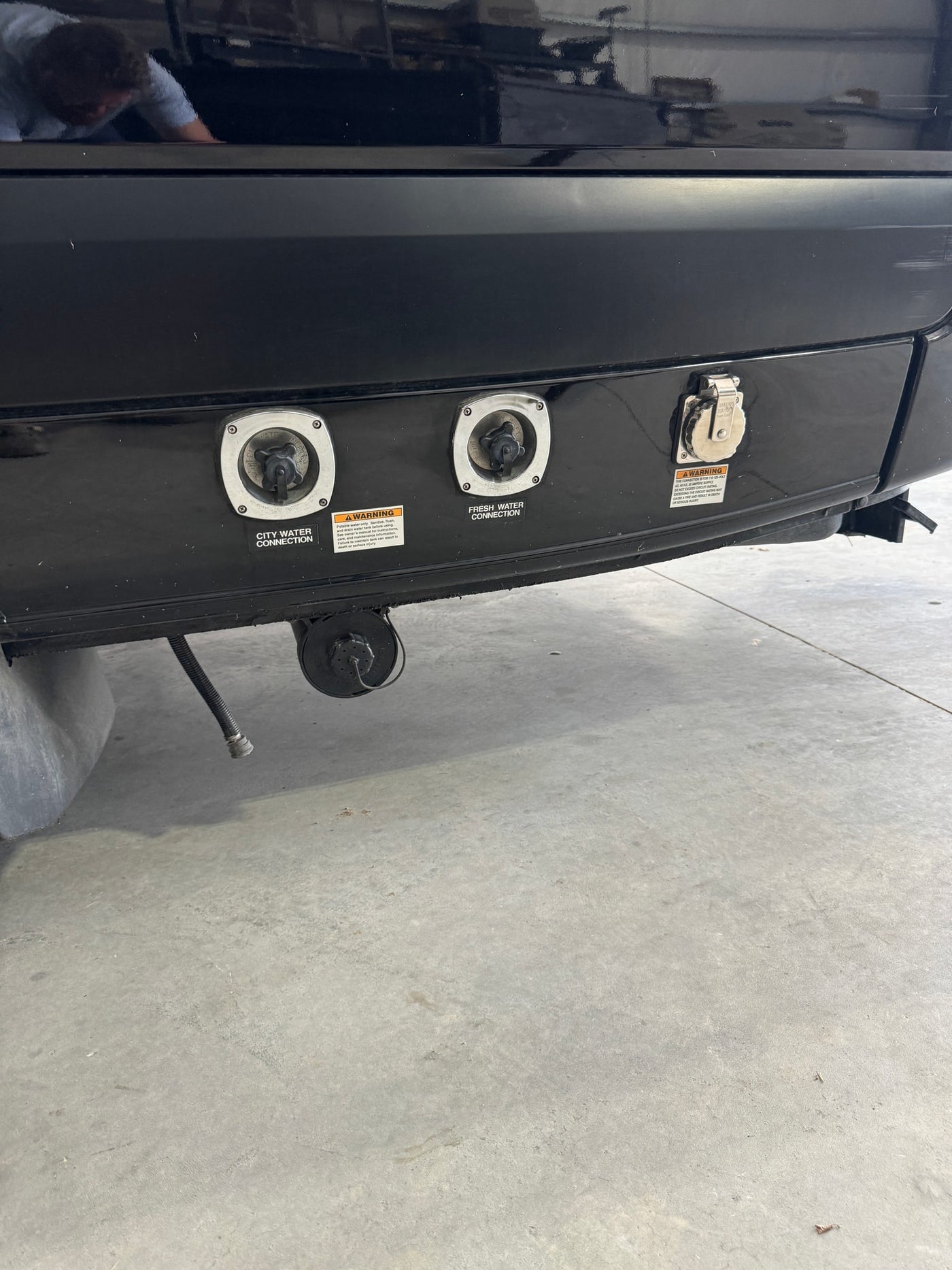RV rental's rear panel: city water, fresh water, and 30-amp power connections for essential hookups at a campsite. — photo 5