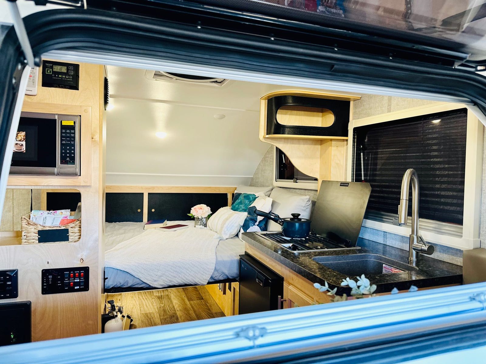 and comfy sleeping area.|Relax in this RV rental's cozy bed with vibrant pillows