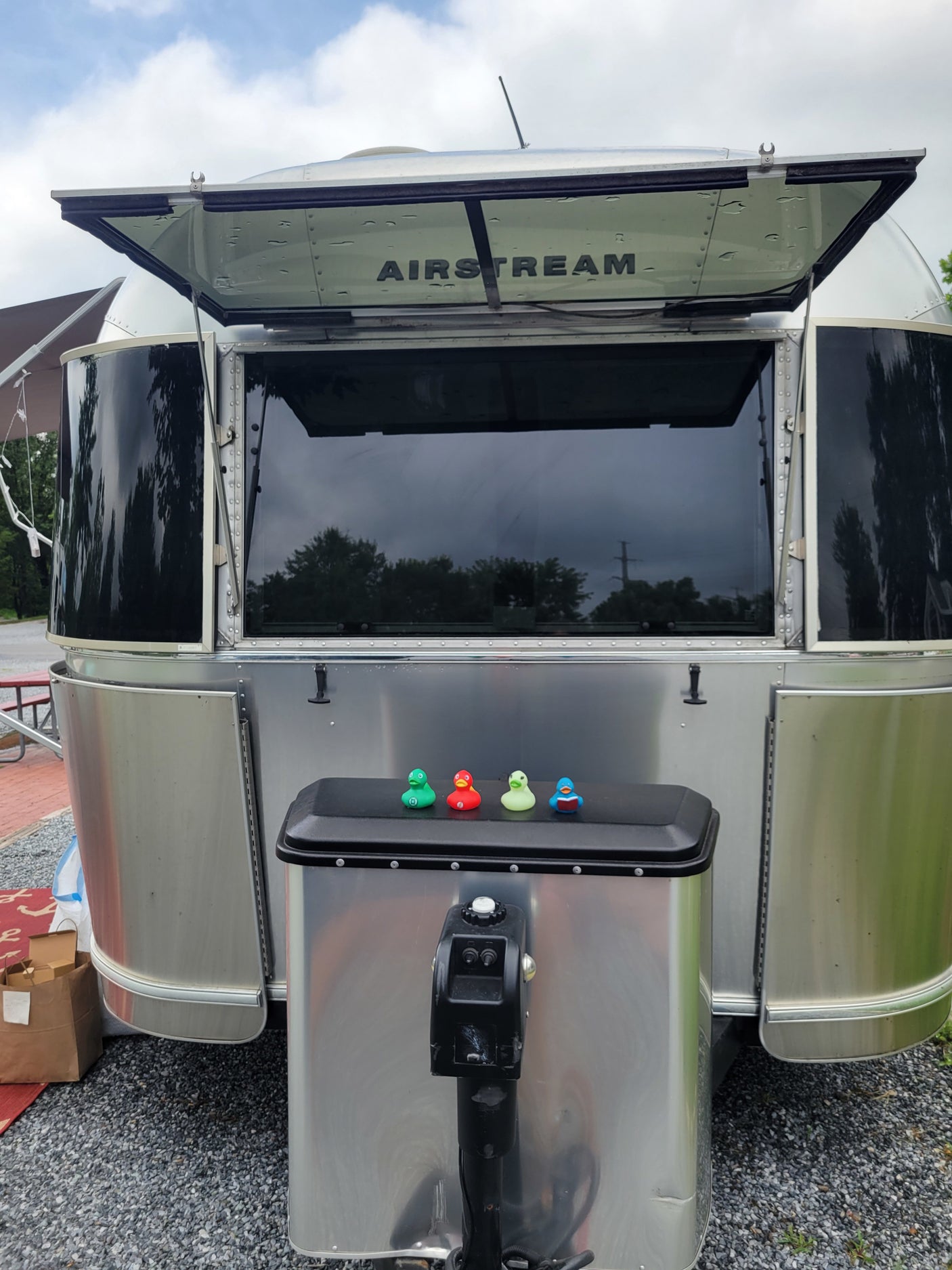 This Airstream RV rental with its front window open features four colorful ducks on the hitch cover. Ready for fun!