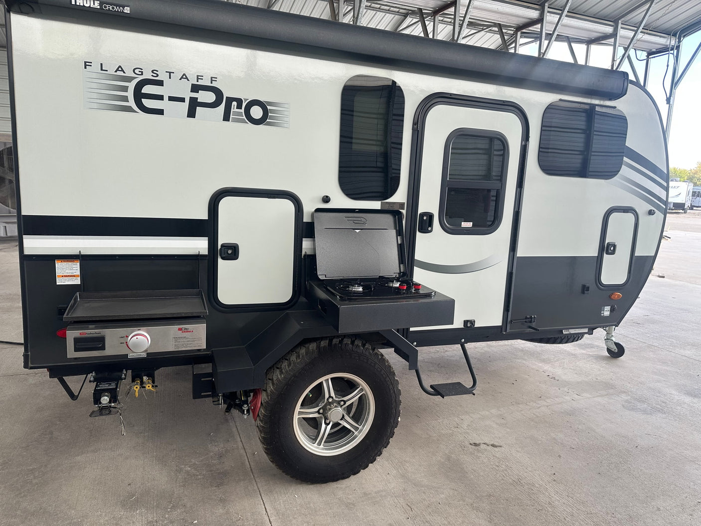 Flagstaff E-Pro RV rental: a compact travel trailer with an integrated outdoor kitchen, perfect for adventures.