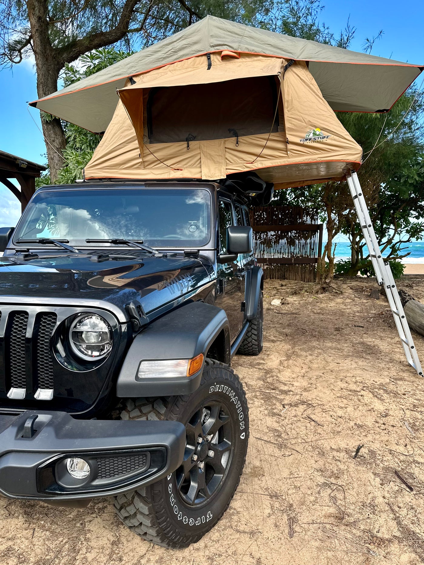 This black Jeep with an open Tuff Stuff rooftop tent on a sandy beach is a perfect RV rental for overland camping adventures. — photo 3