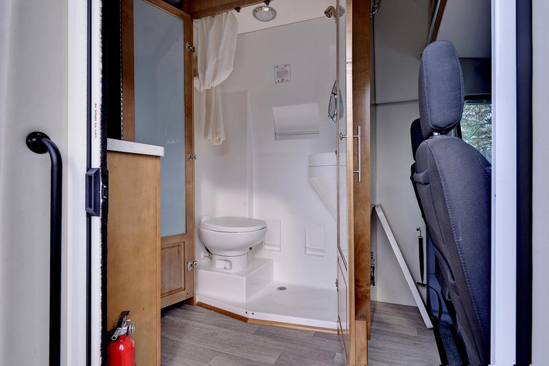 and side steps.|RV rental overhead cabinets with an integrated stereo system. Features light wood