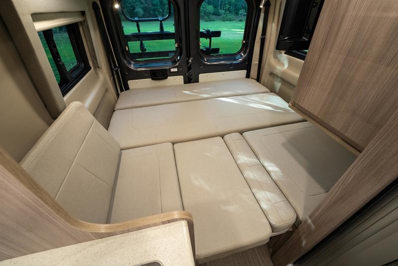 swivel chairs. Visualize the compact campervan interior layout.|Inside an RV rental