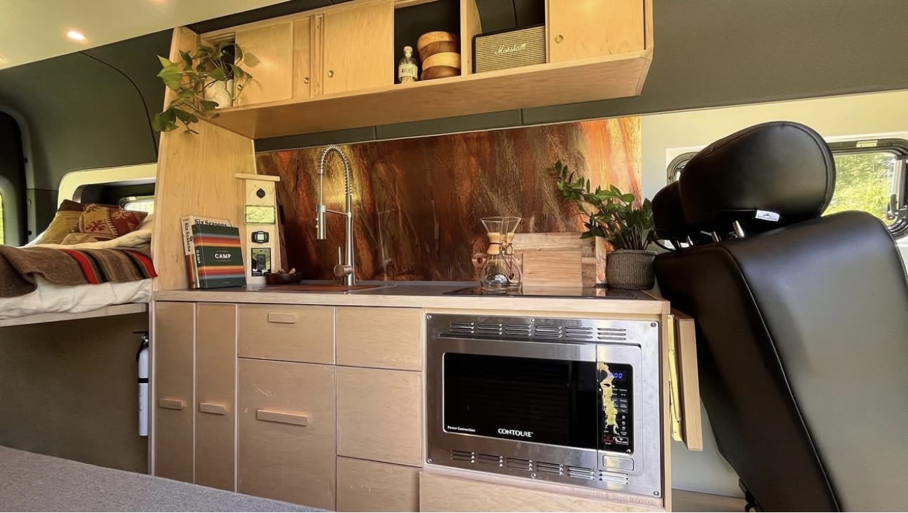 ready for outdoor adventures.|Inside this RV rental: a beautiful camper van kitchen with a microwave