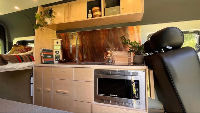 ready for outdoor adventures.|Inside this RV rental: a beautiful camper van kitchen with a microwave