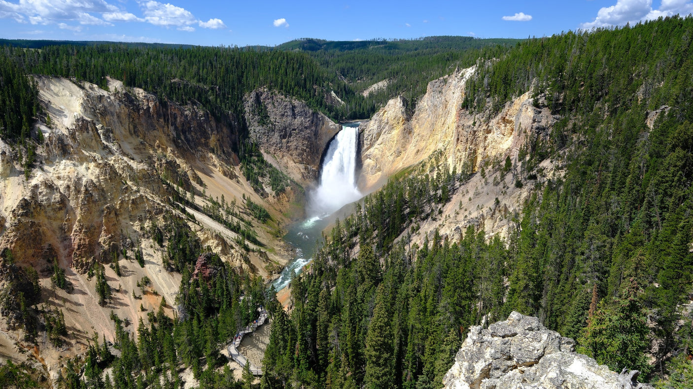 with mountains & fields beyond. Ideal for your RV rental adventure!|Explore Yellowstone's colorful Mammoth Hot Springs travertine terraces. An RV rental makes this natural wonder accessible!|Experience Yellowstone's majestic Lower Falls