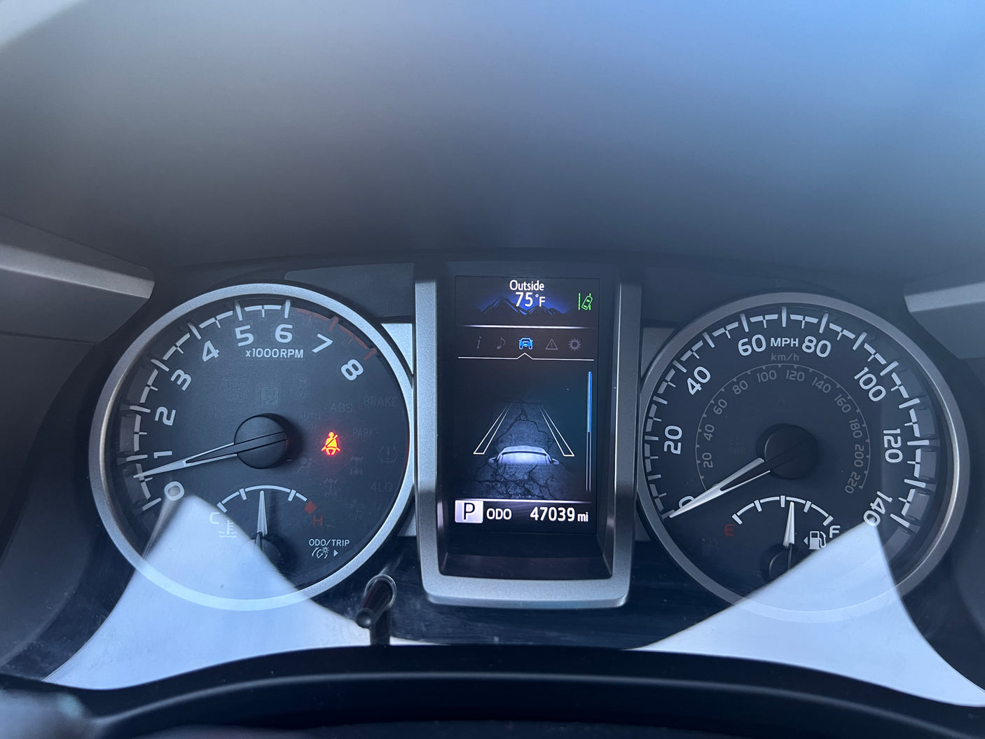Inside an RV rental: dashboard showing 75°F, 47039 miles on the odometer, and various vehicle indicators.