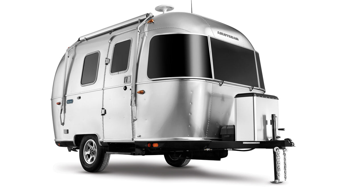 A sleek, silver Airstream travel trailer, perfect for your next rv rental adventure. Iconic rounded design with large tinted windows.