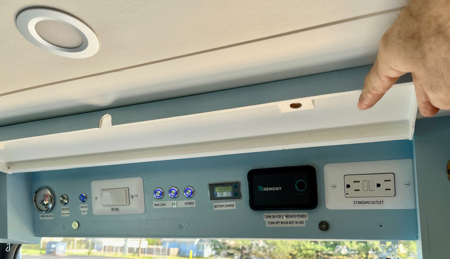 RV rental control panel: Check battery (100%) & water, manage power for cabin, shower, and outlets.
