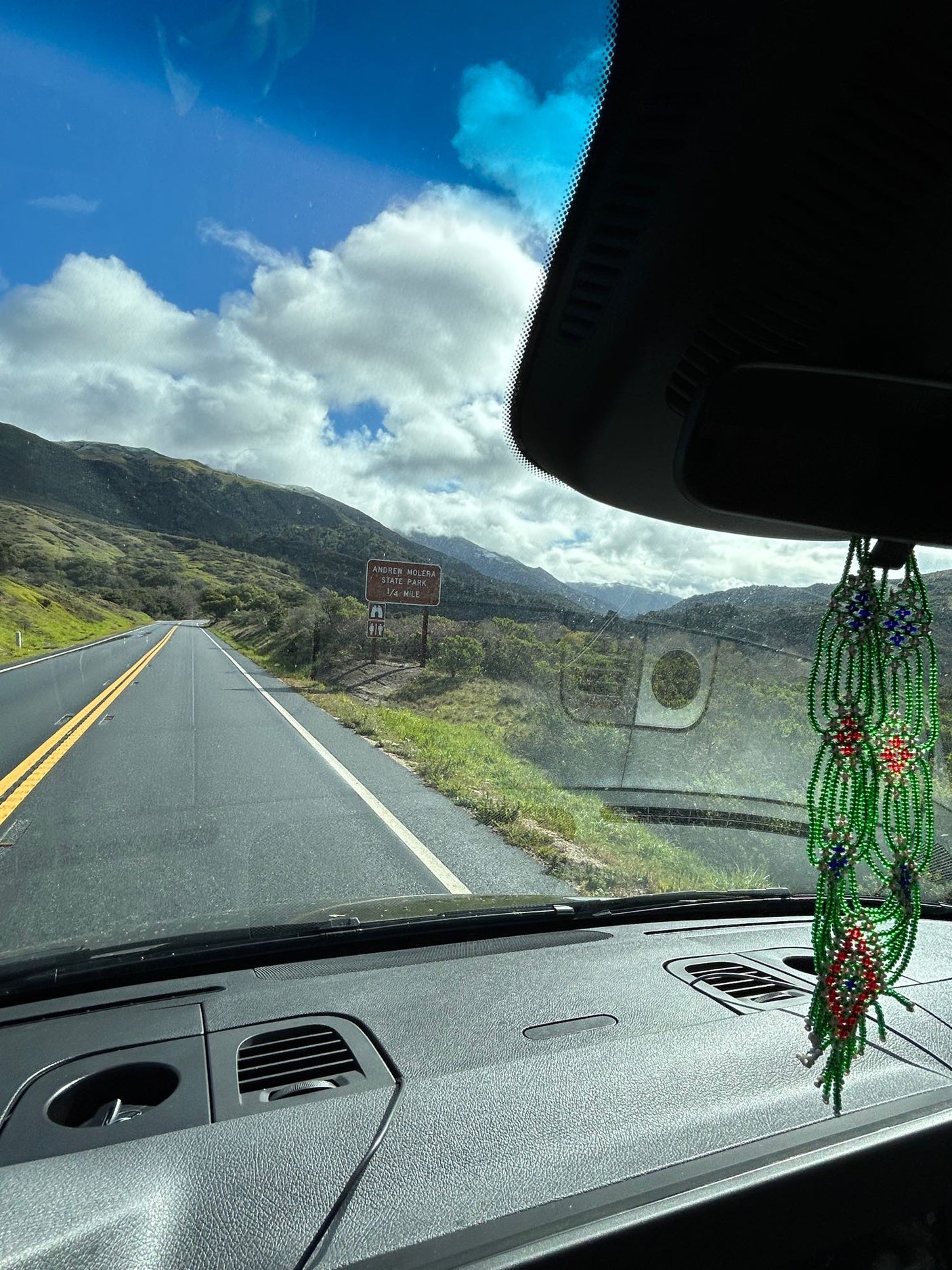 Andrew Molera State Park ahead on a scenic RV rental road trip through green mountains.