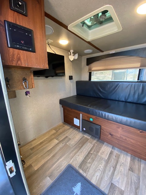 ready for camping.|Step inside this inviting RV rental interior: a comfy bench bed