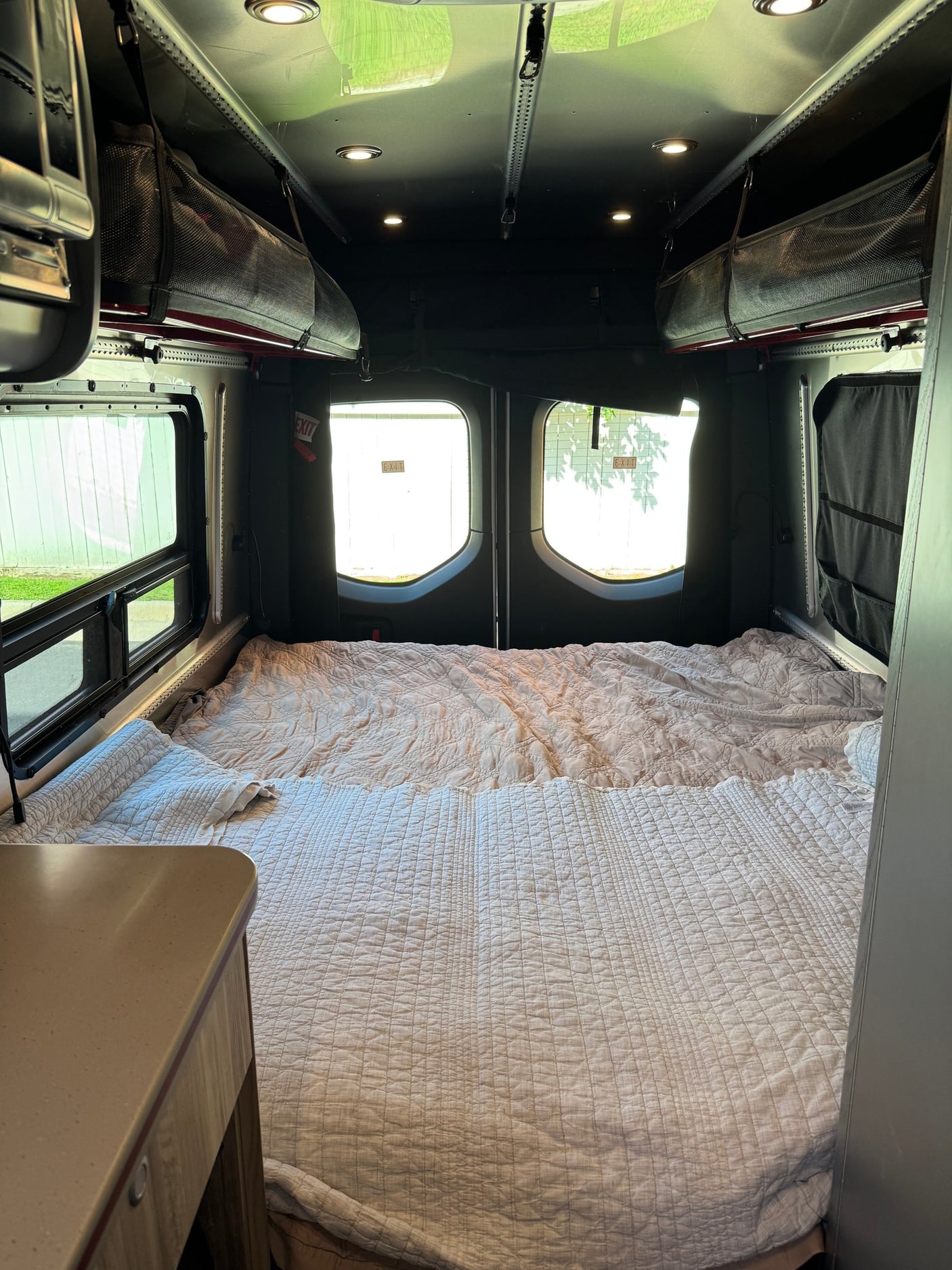 and bright red accent lighting along the edge.|Modern rv rental interior: kitchenette with red LED trim