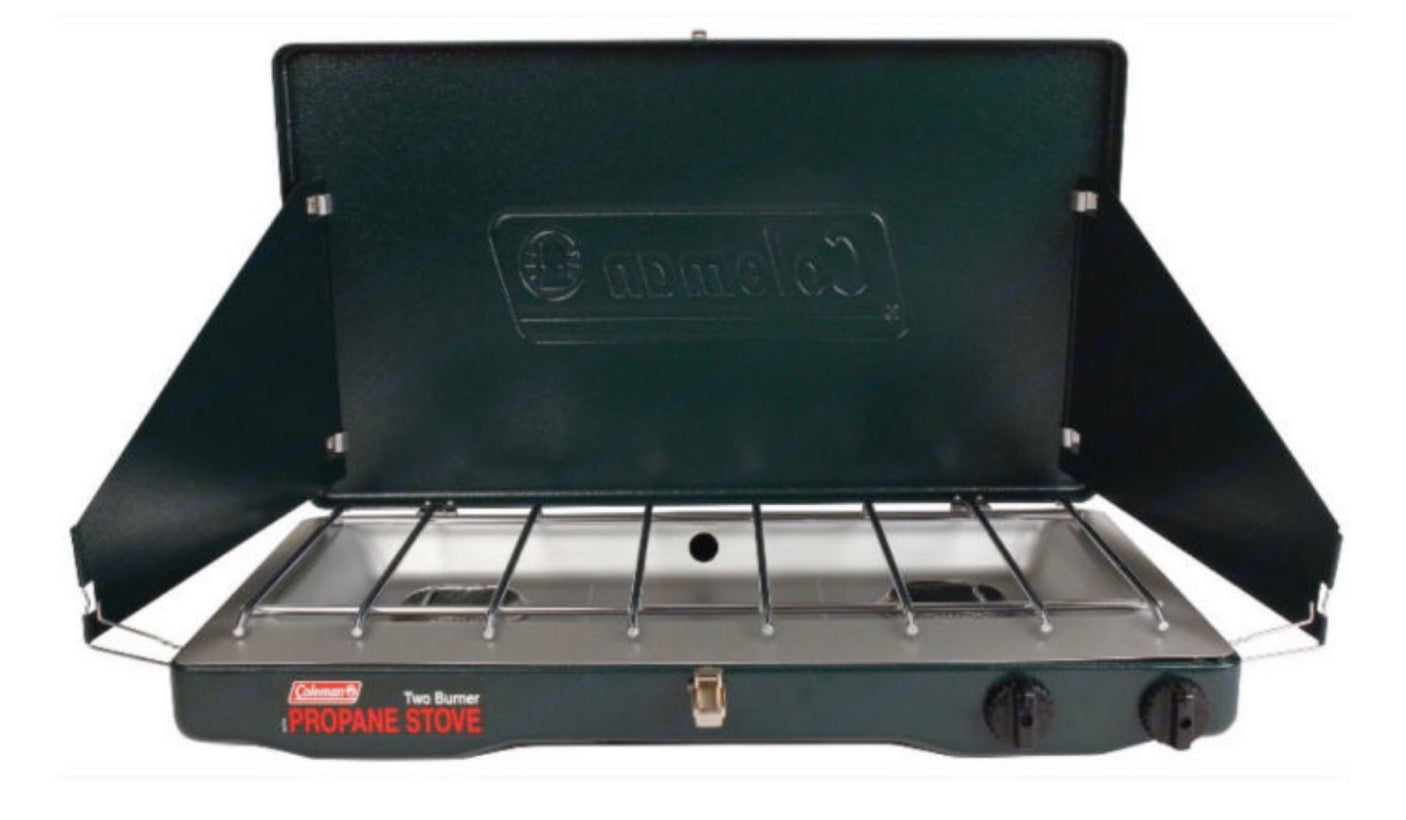 A dark green Coleman 2-burner propane camping stove, open with wind screens, perfect for RV rental and outdoor cooking.
