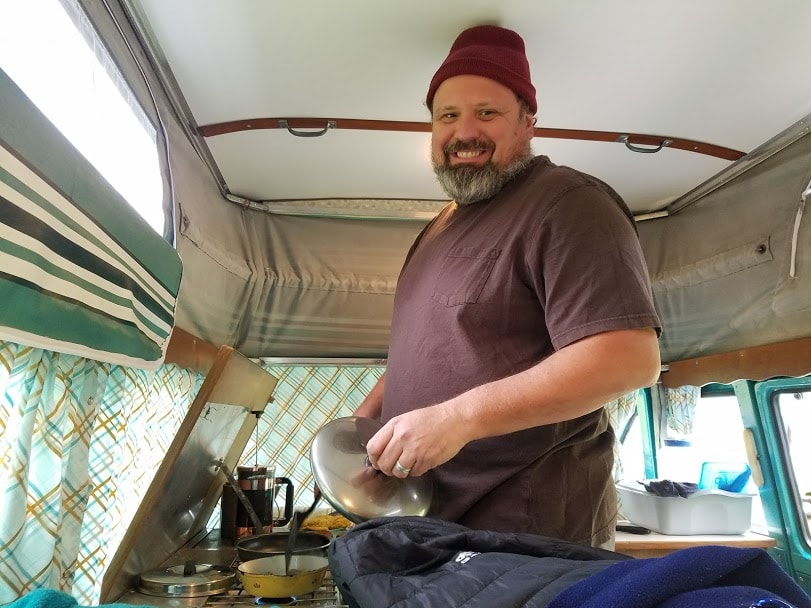 and retro curtains.|Explore our vintage camper van RV rental! Cozy interior with pop-top roof