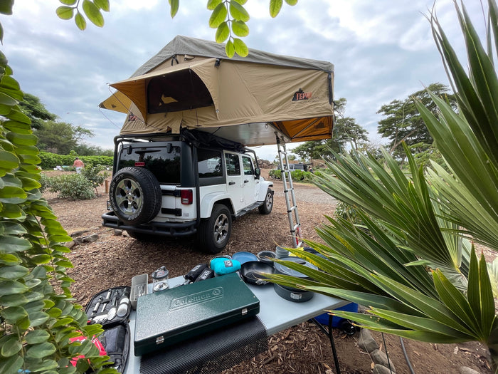 This Jeep with a Tepui rooftop tent offers an RV rental experience for outdoor adventures and camping.