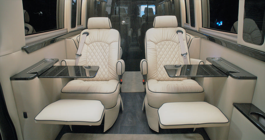 and kitchen unit with a fridge.|Experience comfort in a luxury RV rental. The spacious interior features cream quilted leather seats