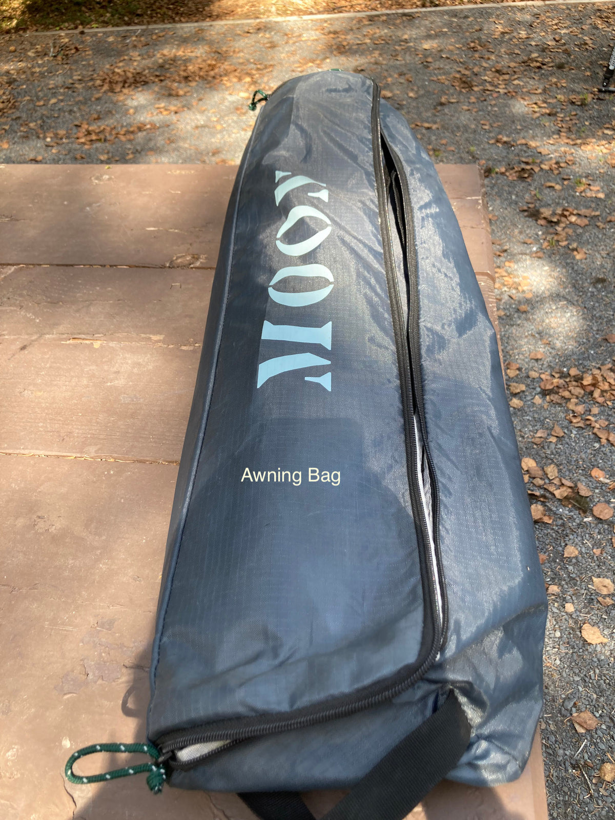 An RV awning bag, branded MOOVI, rests on a rustic picnic table—essential gear for your next RV rental adventure. — photo 16