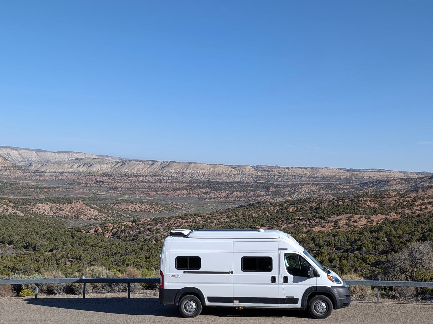 facing sun-drenched golden grasslands under a wide blue sky with cumulus clouds.|An RV rental is silhouetted against a breathtaking starry night sky — photo 4
