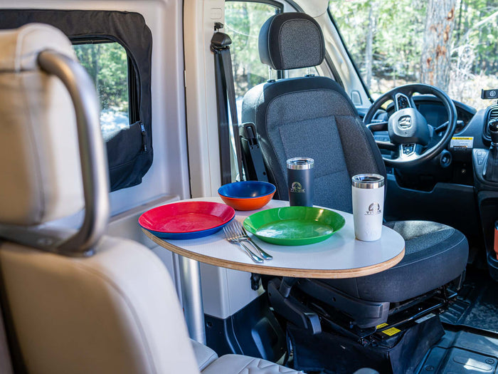 & cabinets. Bed with blue blanket to the right. Ideal for travel & camping.|Inside an RV rental: a compact wet bath with a toilet