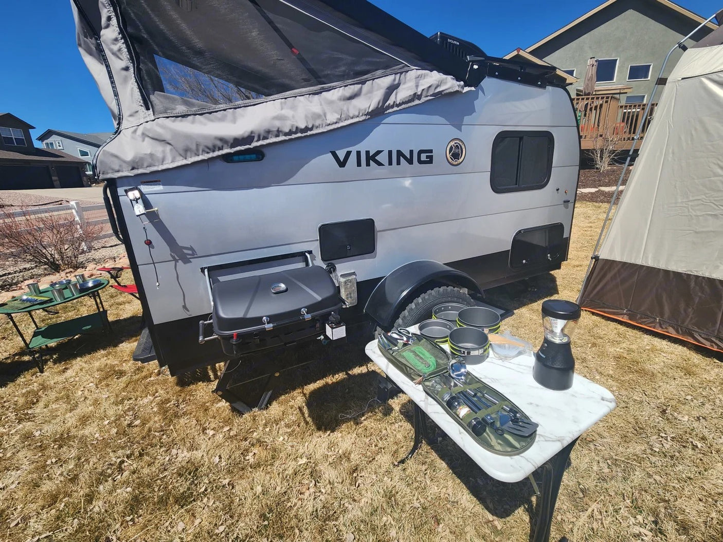 RV rental: Pop-up camper with grill, outdoor kitchen, and tent. Ready for your next camping adventure!