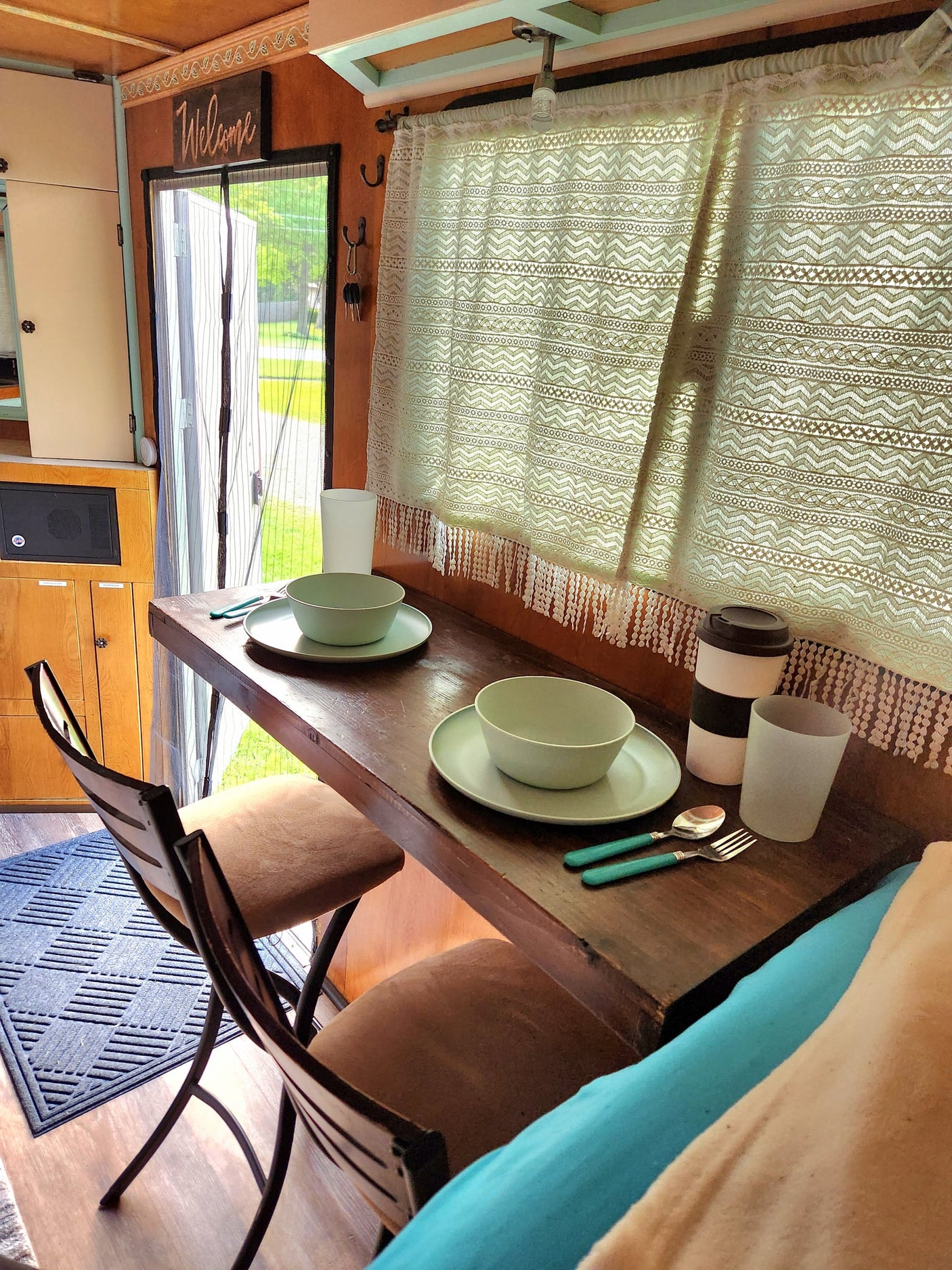 perfect for a family adventure.|Explore the outdoors with this unique RV rental! A custom converted cargo trailer showcasing a cozy bed & organized camping gear.|RV rental: Inside a neat cargo trailer conversion