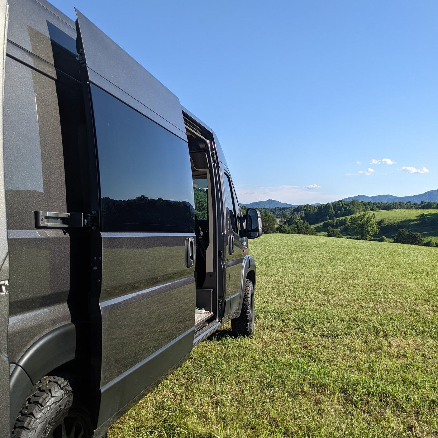 Dark camper van (RV rental) with its side door open