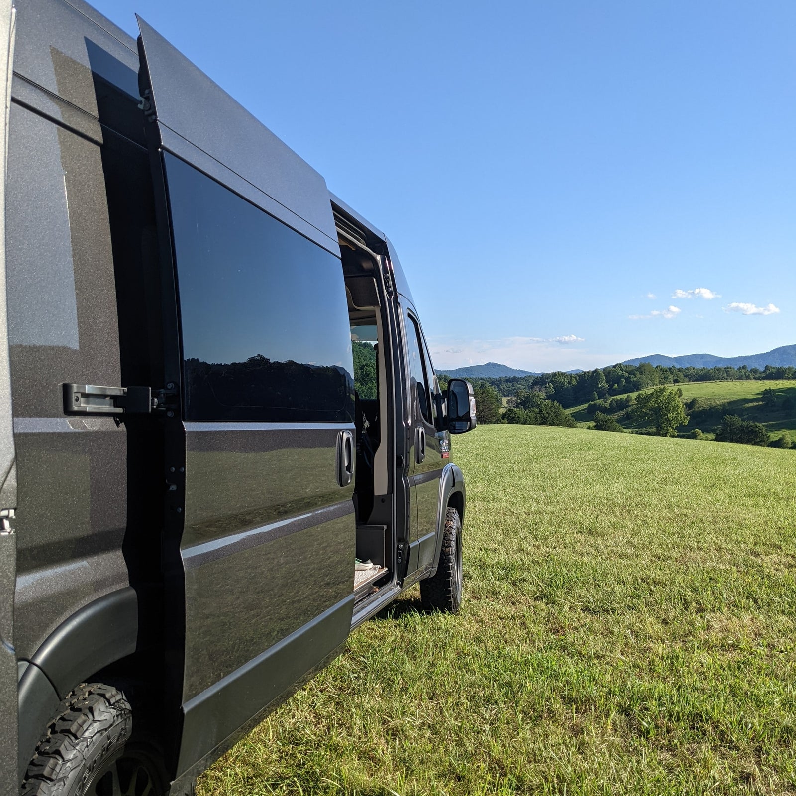 Dark camper van (RV rental) with its side door open