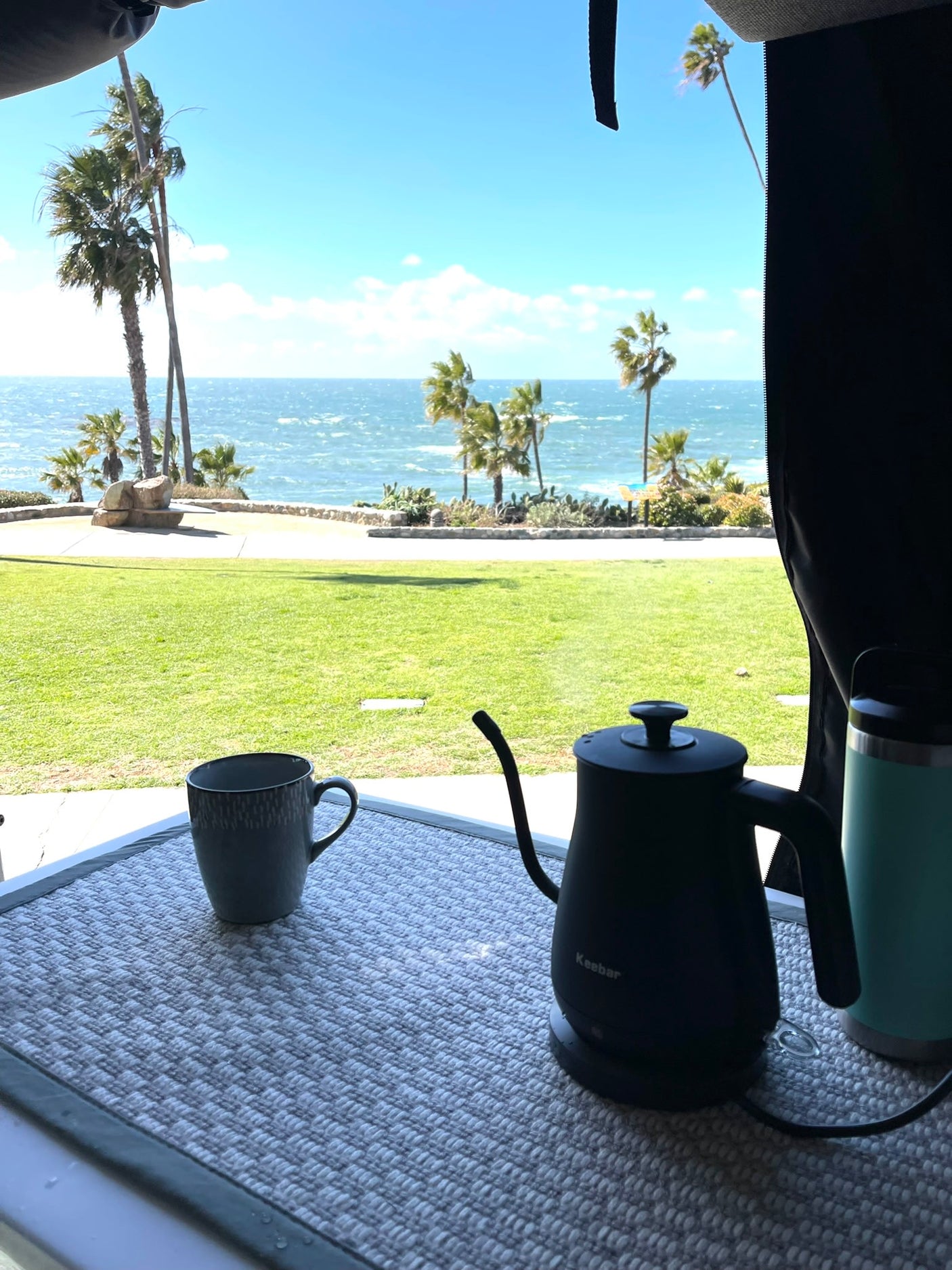 offering a stunning view of a sunny beach and ocean.|Experience epic Big Sur views! This Mercedes RV rental overlooks the Pacific Ocean