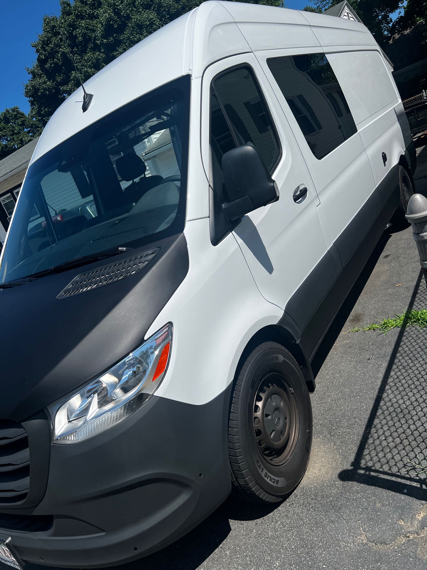 and white cabinetry.|Inside an RV rental: a modern camper van layout with a convertible bed