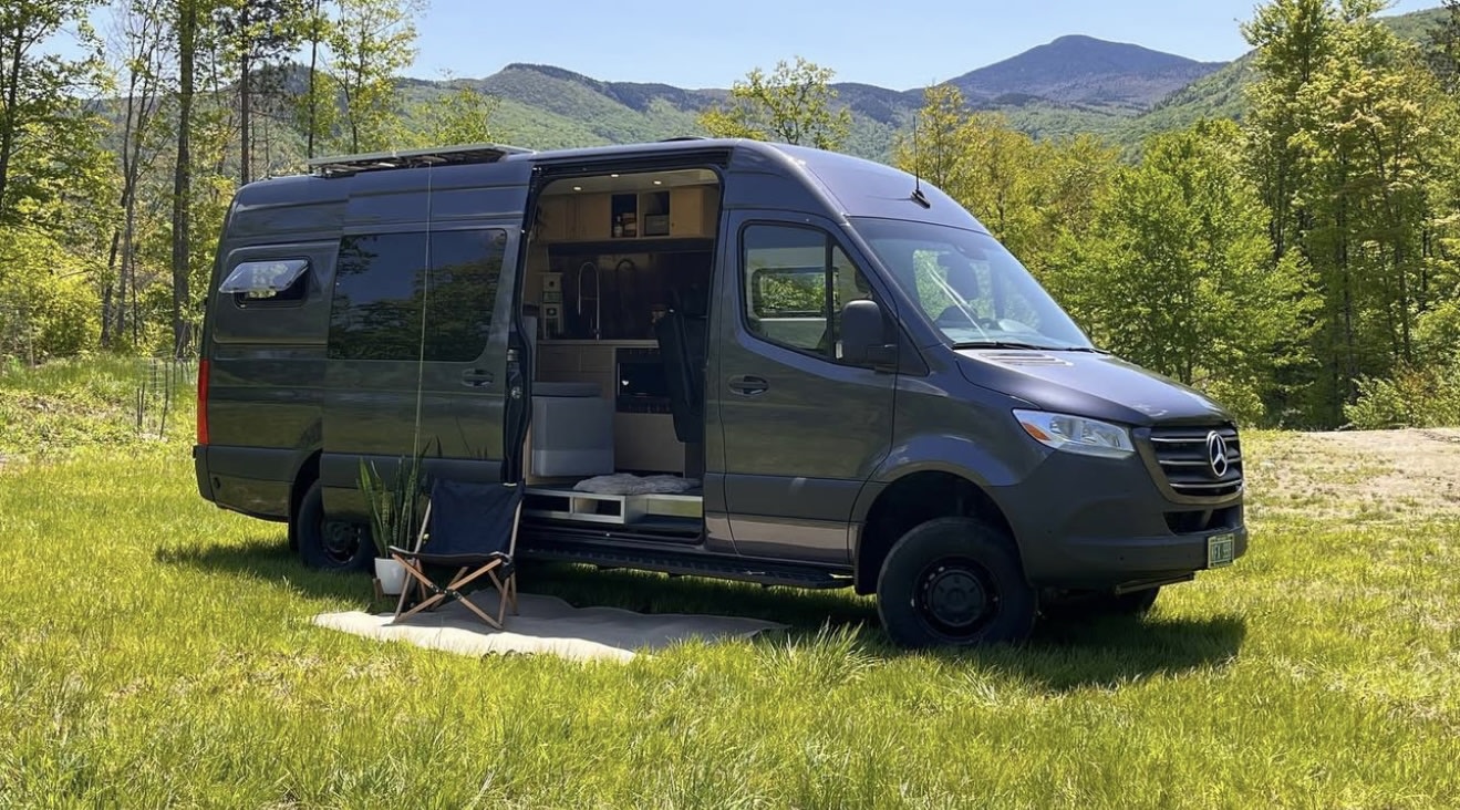 RV rental: A gray camper van parked in a scenic mountain setting